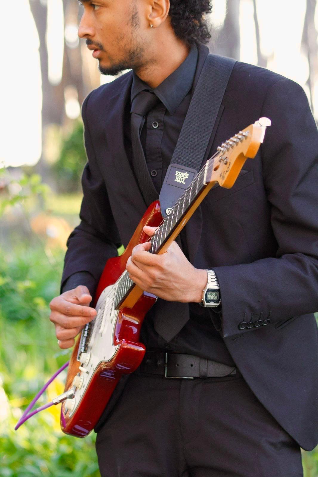 Live guitarist performing with a red electric guitar
